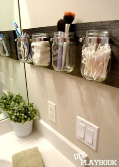 the bathroom is decorated with mason jars and toothbrushes, along with other items