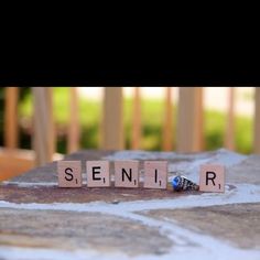 the word senior spelled with scrabble letters on a table