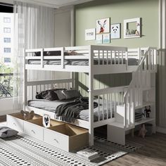 a white bunk bed sitting next to a window