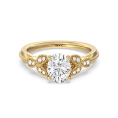 a yellow gold engagement ring with an oval cut diamond surrounded by small white diamonds on the side