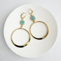 Make a bold statement with these exquisite Gold Hoop Statement Earrings featuring captivating Amazonite stones. Perfectly blending timeless elegance with a modern twist, these hoops showcase the natural beauty of Amazonite, known for its calming and soothing properties. Handcrafted with high-quality materials, these earrings are ideal for elevating both everyday looks and special occasions. Silver Spoon Jewelry, Earrings Gold Hoop, Hoop Dangle Earrings, Dangle Earrings Gold, Amazonite Stone, Spoon Jewelry, Gold Statement Earrings, Earrings In Gold, Bead Jewellery