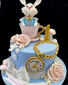 a cake with a rabbit sitting on top of it and a clock in the middle