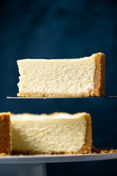 a slice of cheesecake being lifted from a cake plate