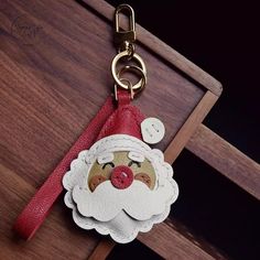 a keychain with a santa claus face on it