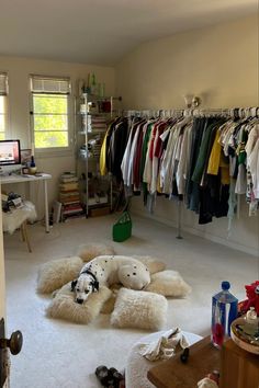 a room filled with lots of clothes on hangers