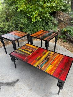 three tables sitting on top of a cement ground