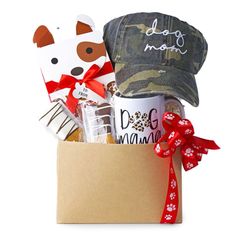 the dog mom gift basket includes coffee, cookies and other treats in a cardboard box