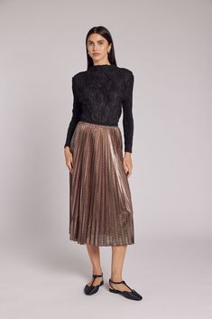 Prepare to captivate every eye in the room with our enchanting Esther Metallic Accordion Pleated Skirt – the ultimate statement piece for your most special occasions. As you move, the accordion pleats gracefully sway and glisten, leaving an indelible impression. Crafted from Luxe Metallic Lamé, this skirt ensures you're effortlessly chic and confident in the crowd. With a soft elastic waistband, you'll experience both secure and all-day comfort during your holiday and New Year celebrations. Midi Accordion Pleated Skirt, Accordion Pleats, Textured Top, Mock Neckline, Pleated Pants, Dress With Cardigan, Chic Design, Types Of Collars, Long Tops