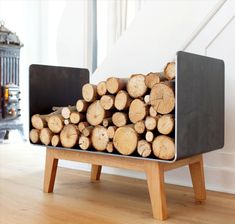 a stack of logs sitting on top of a wooden bench next to a pile of firewood