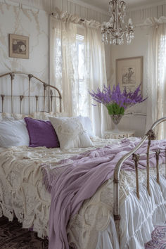 a white bed sitting in a bedroom next to a window covered in purple and white sheets