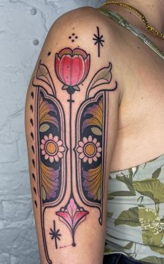 a woman with a tattoo on her arm has a flower in the middle of it