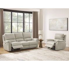 a living room with two recliners and a chair