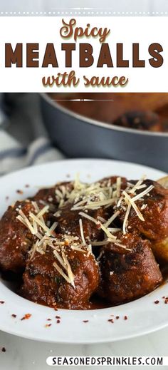 a white plate topped with meatballs covered in grated cheese