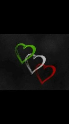 two hearts are in the dark with red, green and white paint on them's sides