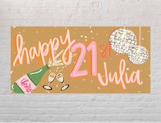 a happy 21st birthday sign on a brick wall with champagne glasses and confetti