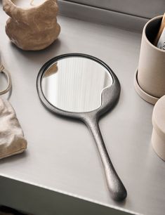 a magnifying glass sitting on top of a table next to some other items