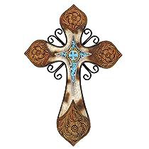 an ornate cross with blue and brown designs on the front, hanging from a wall