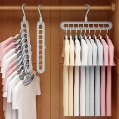 a closet with clothes hanging on hangers