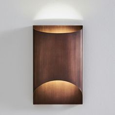 a wall light mounted on the side of a white wall