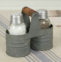 two salt and pepper shakers sitting next to each other