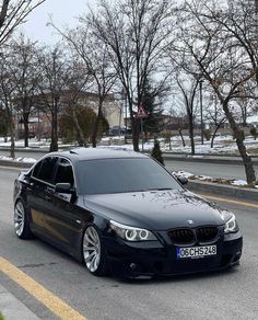 a black car is parked on the street