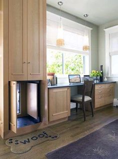 a kitchen with wooden cabinets and an area rug in front of the window that says wow