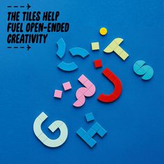 the tiles help fuel - open - ended creativity with colorful letters and shapes on a blue background