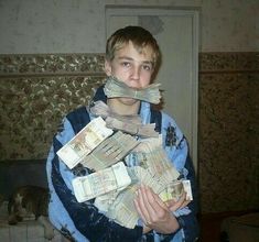 a boy with money wrapped around his mouth