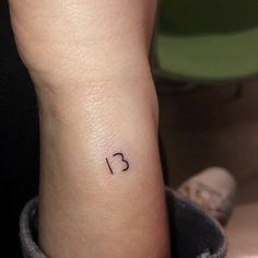 a small wrist tattoo with the number 31 on it's left side ribcage