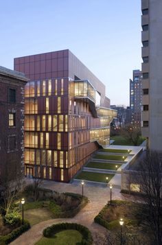 an aerial view of a building at night with lights on the windows and steps leading up to it