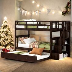 there is a bunk bed with stairs to the top and bottom, next to a christmas tree