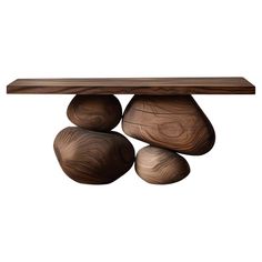 three wooden balls are stacked on top of each other in front of a white background