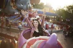 a woman riding on top of a roller coaster