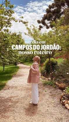 a woman walking down a dirt road with trees in the background and text that reads campos do jordao