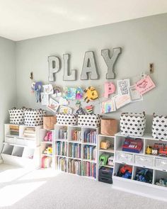 a play room with toys and bookshelves in front of the word play on the wall