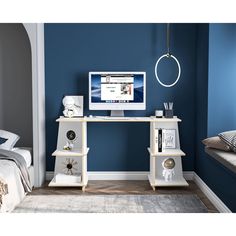 a computer monitor sitting on top of a desk in front of a blue painted wall