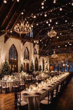 a large banquet hall with tables and chandeliers in the ceiling, decorated for christmas