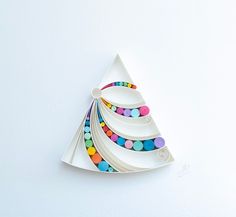 a white plate topped with a colorful christmas tree decoration