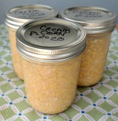 three jars filled with food sitting on top of a table