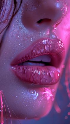 a woman's lips with water droplets on them and pink light shining through the lip