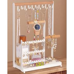 a white jewelry holder on top of a wooden table