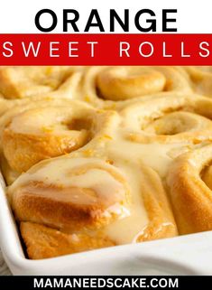 orange sweet rolls in a white baking dish with glaze on top and text overlay