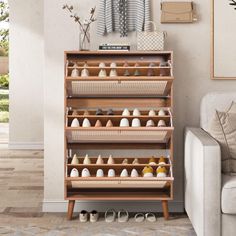 a living room filled with furniture and lots of baskets on top of the shelves next to a white couch