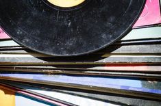 a record player sitting on top of a pile of records