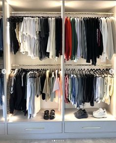 an organized closet with clothes and shoes on the shelves in front of it is lit by lights