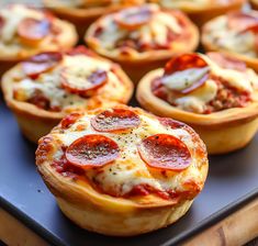 mini pizzas with pepperoni and cheese on a tray