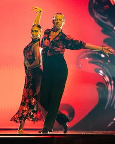 two people are dancing on stage together