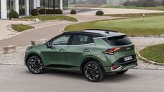 a green car parked in front of a building