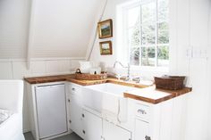 a kitchen with a sink, dishwasher and window in the wall above it