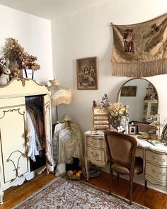 a bedroom with an antique dresser, mirror and chair in it's corner next to a rug